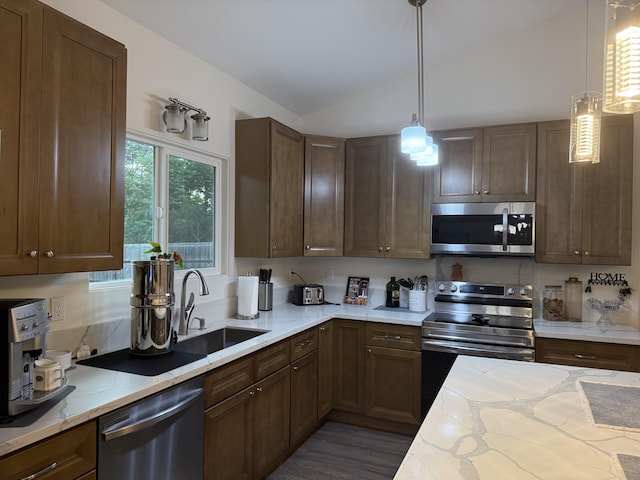 16-1844 34th Ave, Keaau, HI 96749 - kitchen with stainless steel appliances, a sink, lofted ceiling, light stone countertops, and hanging light fixtures