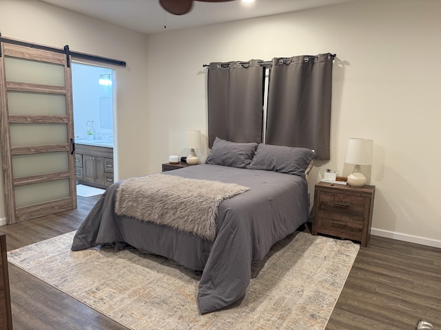 16-1844 34th Ave, Keaau, HI 96749 - bedroom with wood finished floors, a barn door, baseboards, and connected bathroom
