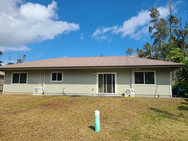 16-1844 34th Ave, Keaau, HI 96749 - rear view of property featuring a cooling unit, metal roof, and a lawn