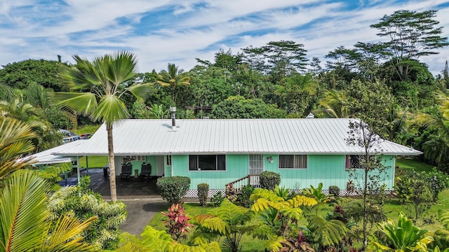 15-1477 17th Ave, Keaau, HI 96749 - view of front of home with asphalt driveway and metal roof