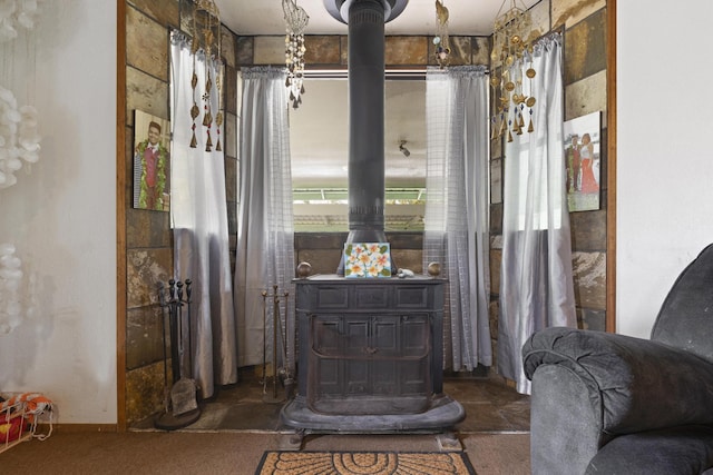 15-1477 17th Ave, Keaau, HI 96749 - detailed view of a wood stove, carpet flooring, and baseboards