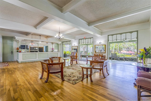 75-5776 Kuakini Hwy Unit 335, Kailua-Kona, HI 96740 - living room featuring light wood-style flooring, a chandelier, beamed ceiling, a textured ceiling, and coffered ceiling