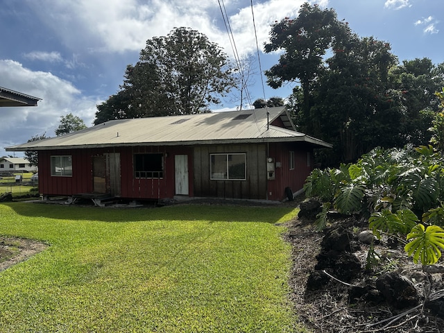 199 Kehaulani St Unit 3, Hilo, HI 96720 - rear view of house featuring a lawn and board and batten siding