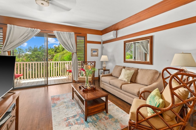 2253 Poipu Rd Unit 411, Koloa, HI 96756 - living room with a wall unit AC, plenty of natural light, wood finished floors, and ceiling fan