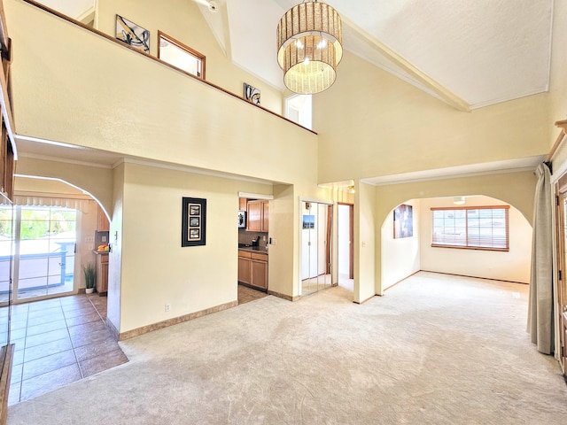726-A Waianuenue Ave, Hilo, HI 96720 - unfurnished living room with arched walkways, light carpet, ornamental molding, healthy amount of natural light, and baseboards