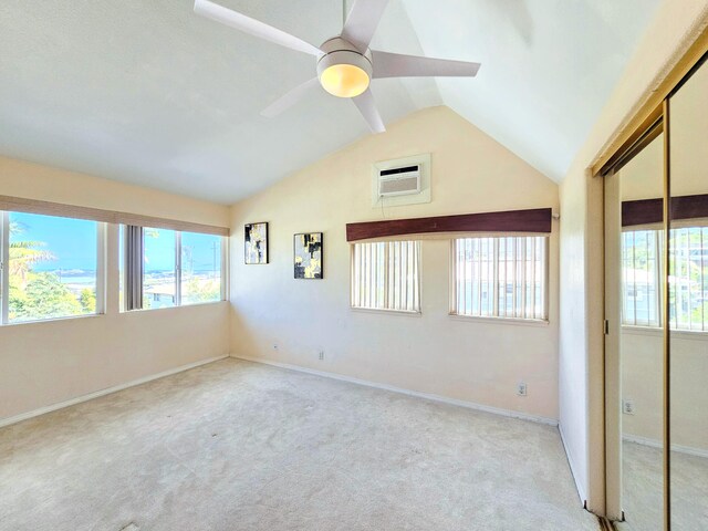 726-A Waianuenue Ave, Hilo, HI 96720 - carpeted empty room featuring a wall mounted air conditioner, ceiling fan, lofted ceiling, plenty of natural light, and baseboards