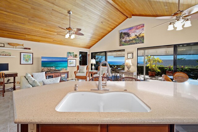 76-247 Keakealani Dr, Kailua-Kona, HI 96740 - kitchen featuring open floor plan, ceiling fan, a sink, wooden ceiling with exposed beams, and light stone counters