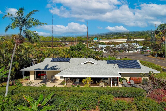 76-247 Keakealani Dr, Kailua-Kona, HI 96740 - view of front of property featuring a patio, solar panels, and outdoor dining space