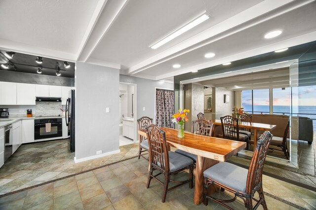 1677 Pee Rd Unit B2, Koloa, HI 96756 - dining space with baseboards and light stone finish floors