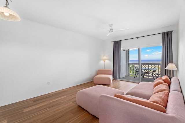73-1101 Nuuanu Pl Unit D204, Kailua-Kona, HI 96740 - living room featuring wood finished floors, a ceiling fan, and a water view