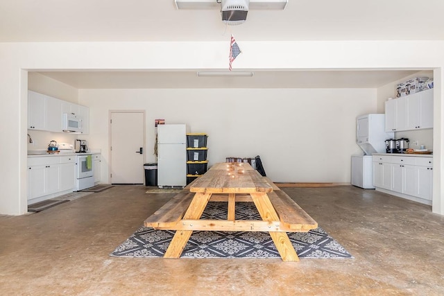 46-3910 Kahana Dr, Honokaa, HI 96727 - garage featuring freestanding refrigerator, stacked washer and clothes dryer, and a sink