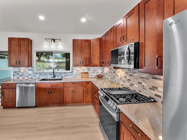 94-5797 Kahiki St, Naalehu, HI 96772 - kitchen featuring appliances with stainless steel finishes, a sink, light wood-style flooring, backsplash, and brown cabinetry