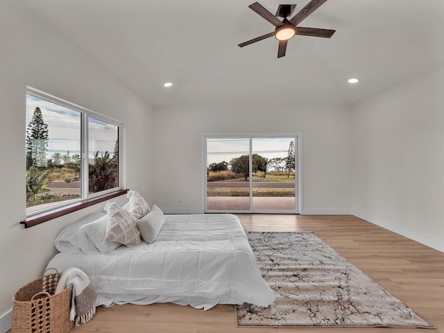 94-5797 Kahiki St, Naalehu, HI 96772 - bedroom with access to exterior, wood finished floors, recessed lighting, and baseboards