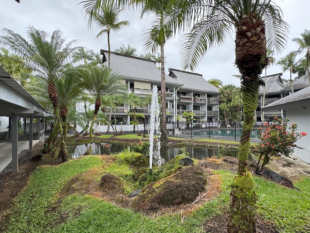 400 Hualani St Unit 2207, Hilo, HI 96720 - back of house featuring a water view and metal roof