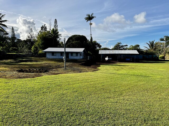 15-594 Puni Mauka Loop, Pahoa, HI 96778 - view of green lawn featuring a carport