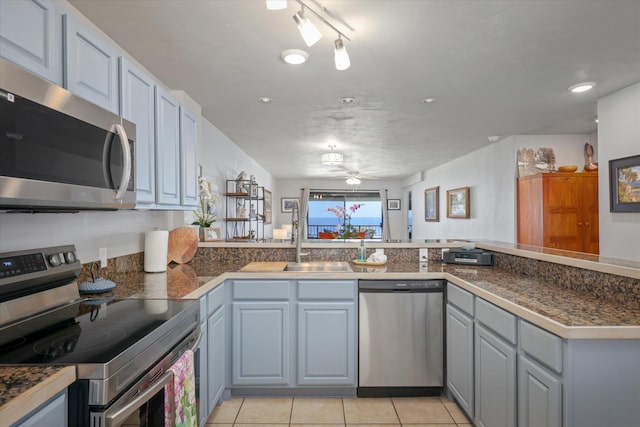77-6585 Seaview Cir Unit 303, Kailua-Kona, HI 96740 - kitchen featuring appliances with stainless steel finishes, a sink, tile counters, light tile patterned floors, and recessed lighting