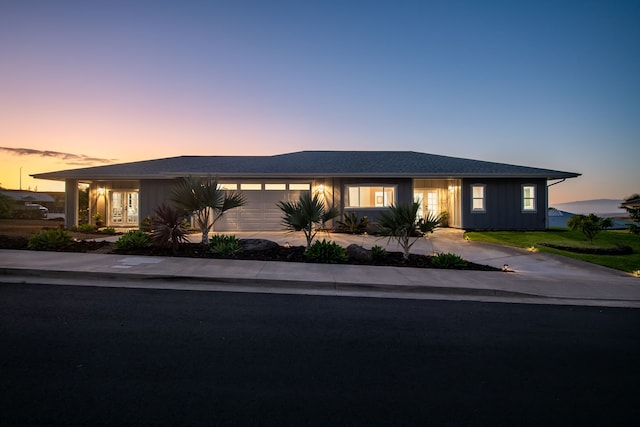68-3635 Haena St, Waikoloa, HI 96738 - ranch-style house featuring board and batten siding, a garage, driveway, and french doors