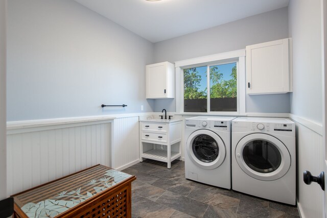 68-3635 Haena St, Waikoloa, HI 96738 - laundry area with cabinet space, separate washer and dryer, a wainscoted wall, and dark stone finish floors