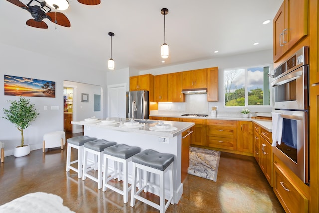 15-2000 5th Ave, Keaau, HI 96749 - kitchen featuring stainless steel appliances, concrete flooring, light countertops, ceiling fan, and a kitchen bar