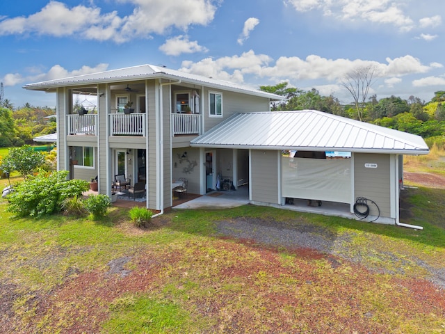 15-2000 5th Ave, Keaau, HI 96749 - back of house with a balcony, a patio area, and metal roof