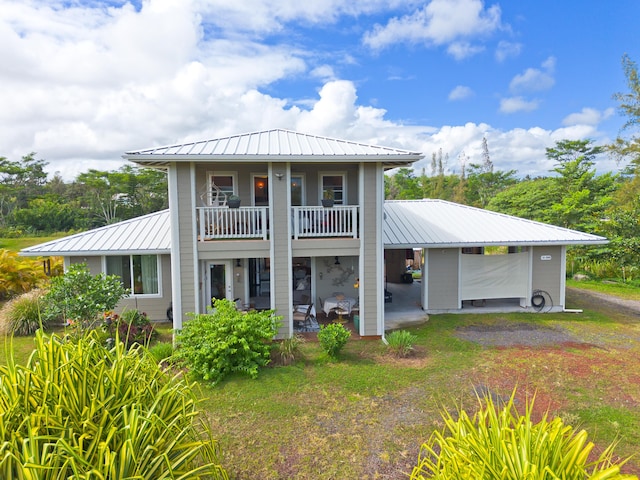 15-2000 5th Ave, Keaau, HI 96749 - back of property featuring metal roof, a balcony, a patio, and a standing seam roof