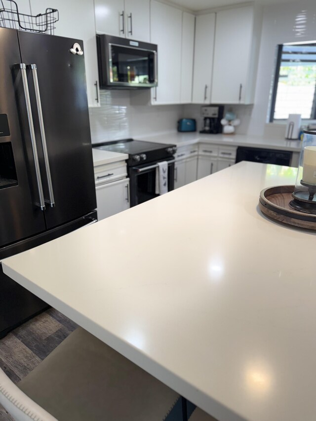 4194 Kekuanaoa Ln, Princeville, HI 96722 - kitchen featuring black / electric stove, fridge with ice dispenser, light countertops, white cabinetry, and decorative backsplash