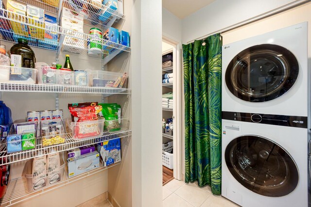 78-7054 Kamehameha Iii Rd Unit 803, Kailua-Kona, HI 96740 - laundry room featuring stacked washing machine and dryer and tile patterned floors
