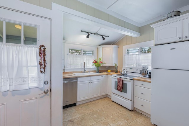 4463 Makaha Rd, Kapaa, HI 96746 - kitchen with white appliances, a sink, white cabinetry, light countertops, and rail lighting