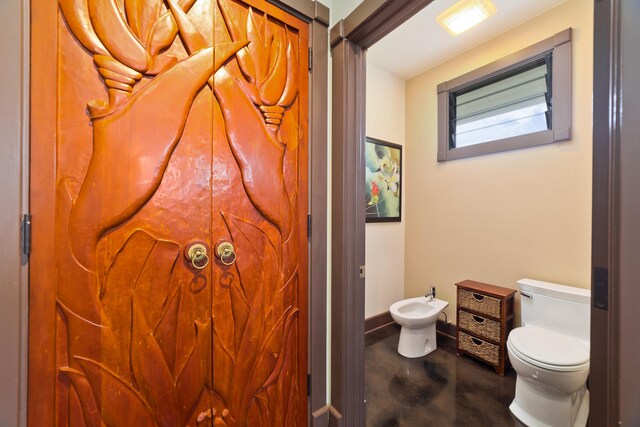 17-250 Meaulu St, Keaau, HI 96749 - bathroom with finished concrete flooring, toilet, a bidet, and baseboards