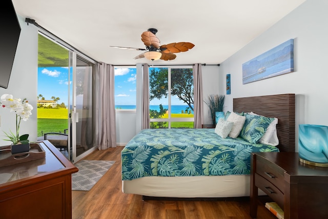 3811 Edward Rd Unit 8204, Princeville, HI 96722 - bedroom featuring access to outside, a water view, wood finished floors, and a ceiling fan