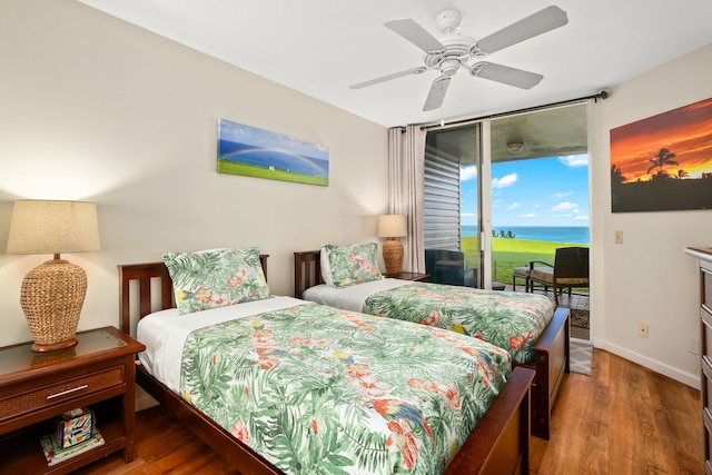 3811 Edward Rd Unit 8204, Princeville, HI 96722 - bedroom featuring access to outside, wood finished floors, a water view, and ceiling fan