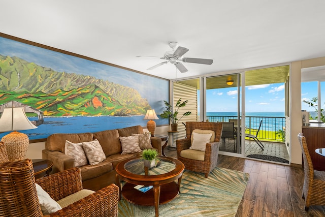 3811 Edward Rd Unit 8204, Princeville, HI 96722 - living area with wood finished floors, ceiling fan, healthy amount of natural light, expansive windows, and a water view