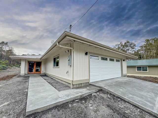 11-3782-A Nahelenani St, Volcano, HI 96785 - view of side of home featuring concrete driveway and an attached garage