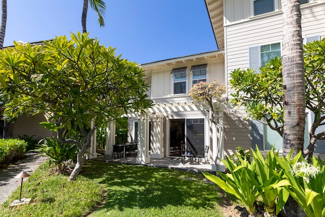 69-200 Pohakulana Pl Unit L1, Waikoloa, HI 96738 - back of property featuring a pergola, a patio, a yard, and board and batten siding
