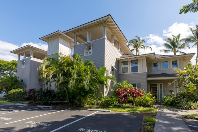 69-200 Pohakulana Pl Unit L1, Waikoloa, HI 96738 - view of front facade with board and batten siding and uncovered parking