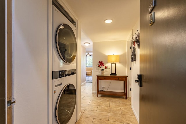 75-5865 Walua Rd Unit E631, Kailua-Kona, HI 96740 - laundry area featuring stacked washer and clothes dryer, light tile patterned flooring, and baseboards