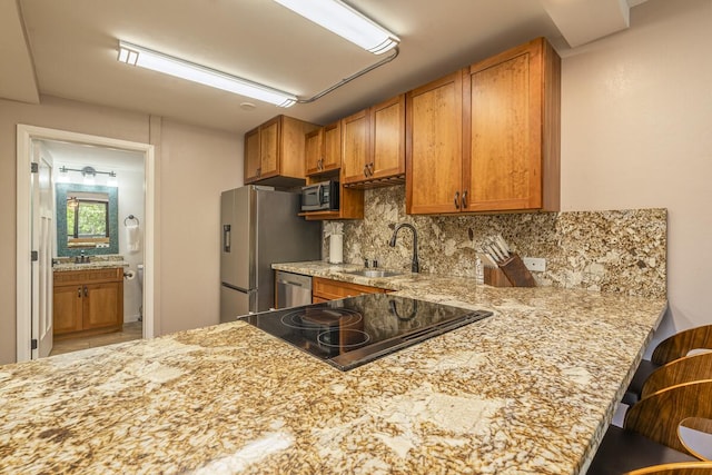 75-5865 Walua Rd Unit E631, Kailua-Kona, HI 96740 - kitchen with brown cabinets, decorative backsplash, appliances with stainless steel finishes, and a sink
