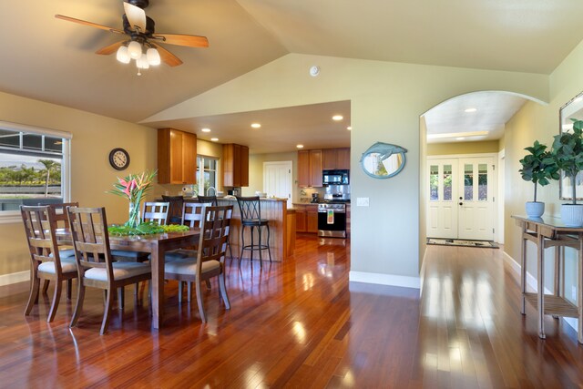 68-3744 Ua Noe Pl, Waikoloa, HI 96738 - dining space with arched walkways, vaulted ceiling, dark wood-style flooring, a ceiling fan, and baseboards