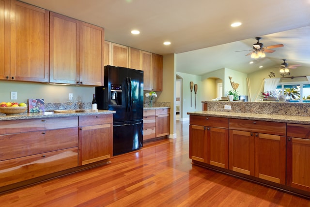 68-3744 Ua Noe Pl, Waikoloa, HI 96738 - kitchen with black fridge with ice dispenser, light wood-style flooring, arched walkways, ceiling fan, and vaulted ceiling
