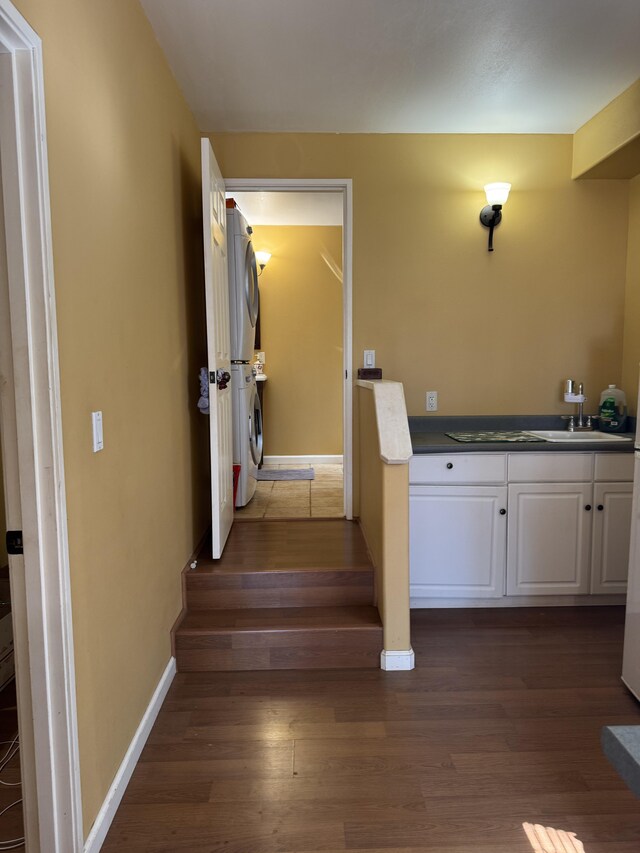 68-3744 Ua Noe Pl, Waikoloa, HI 96738 - staircase featuring estacked washer and dryer, wood finished floors, and baseboards