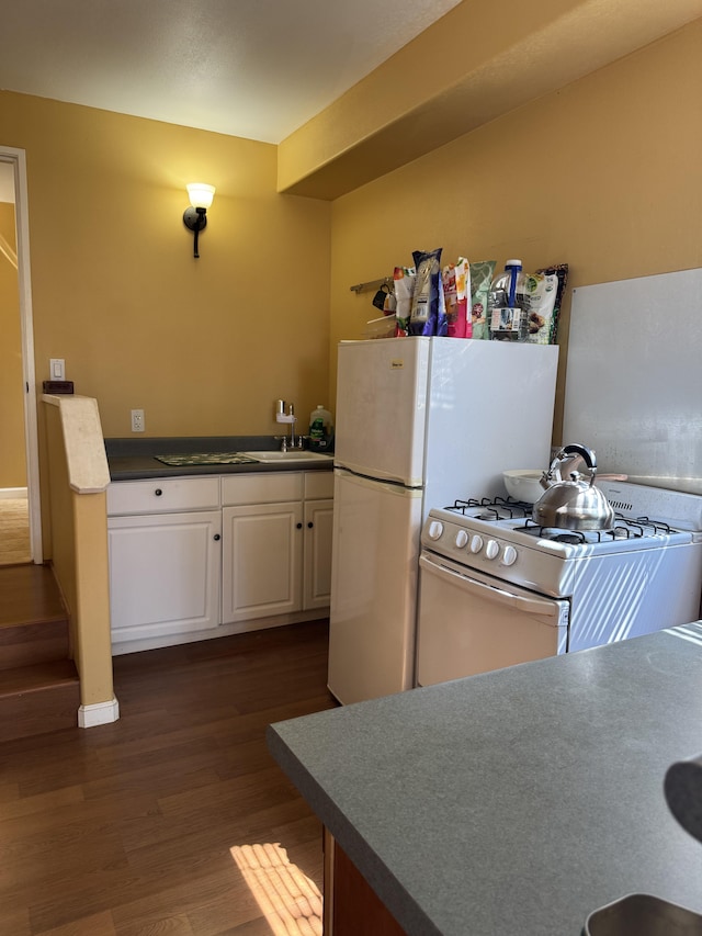 68-3744 Ua Noe Pl, Waikoloa, HI 96738 - kitchen featuring white gas range oven, dark wood-type flooring, white cabinetry, a sink, and dark countertops