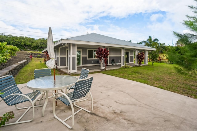 94-6661 Kamaoa Rd, Naalehu, HI 96772 - rear view of property with a patio, a lawn, outdoor dining area, and metal roof