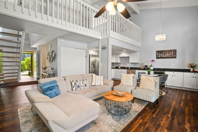 3880 Wyllie Rd Unit 5B, Princeville, HI 96722 - living room with high vaulted ceiling, dark wood-style floors, ceiling fan, a chandelier, and beam ceiling
