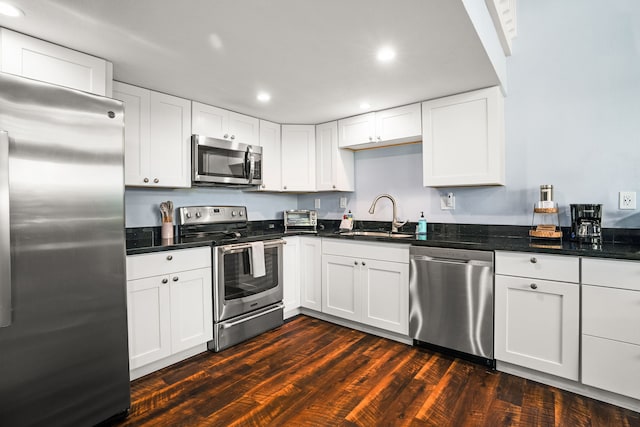 3880 Wyllie Rd Unit 5B, Princeville, HI 96722 - kitchen with stainless steel appliances, a sink, dark wood-style flooring, white cabinets, and recessed lighting