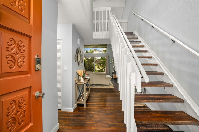 3880 Wyllie Rd Unit 5B, Princeville, HI 96722 - entrance foyer featuring stairs, dark wood-style floors, and baseboards