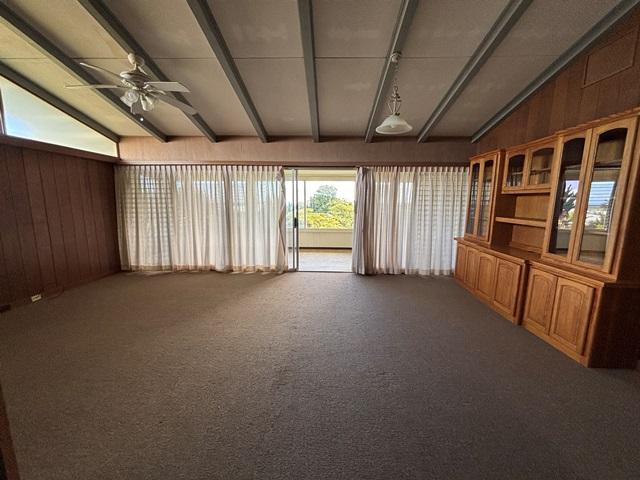273 Iwalani St, Hilo, HI 96720 - unfurnished sunroom with wood walls and carpet flooring