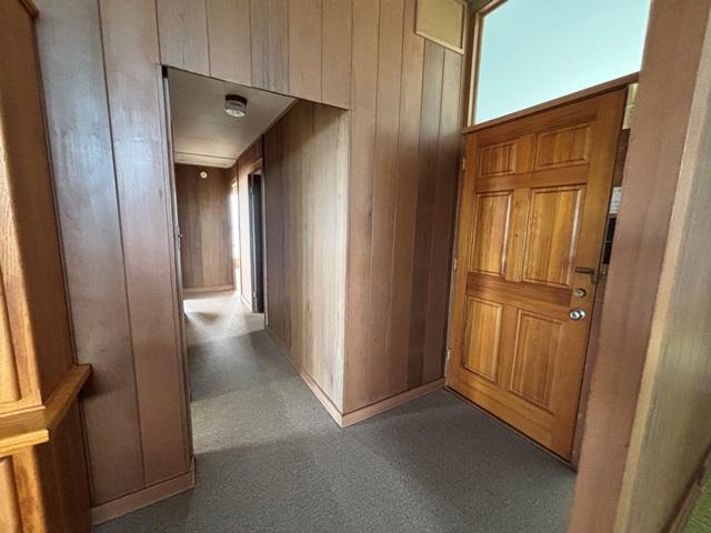 273 Iwalani St, Hilo, HI 96720 - hall with wooden walls and carpet flooring