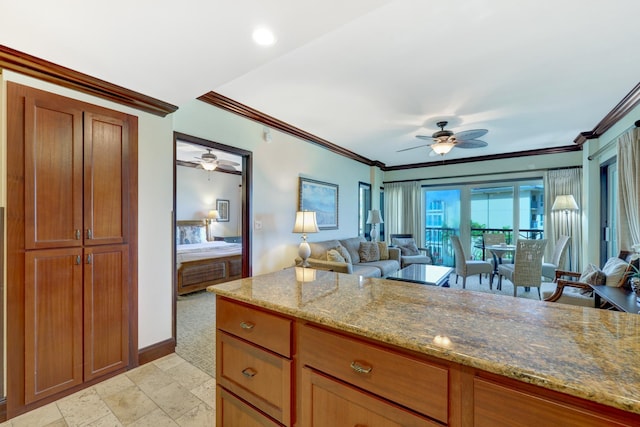 4-820 Kuhio Hwy Unit H304, Kapaa, HI 96746 - kitchen featuring a ceiling fan, open floor plan, light stone counters, stone tile flooring, and ornamental molding