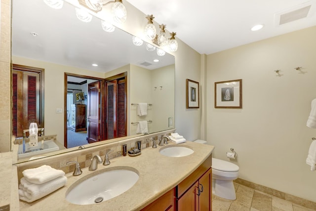 4-820 Kuhio Hwy Unit H304, Kapaa, HI 96746 - bathroom with toilet, double vanity, baseboards, and recessed lighting