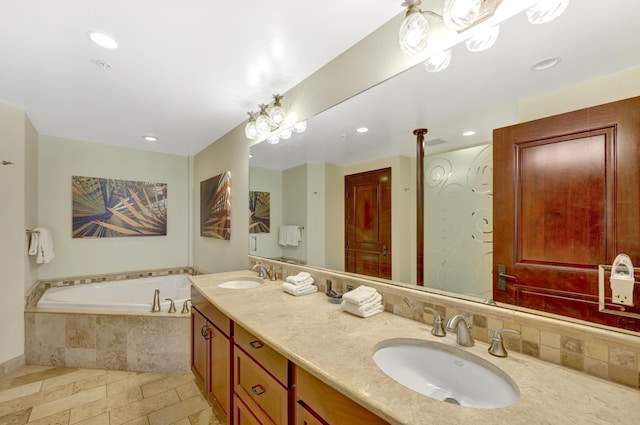 4-820 Kuhio Hwy Unit H304, Kapaa, HI 96746 - bathroom with a garden tub, double vanity, recessed lighting, backsplash, and stone tile floors